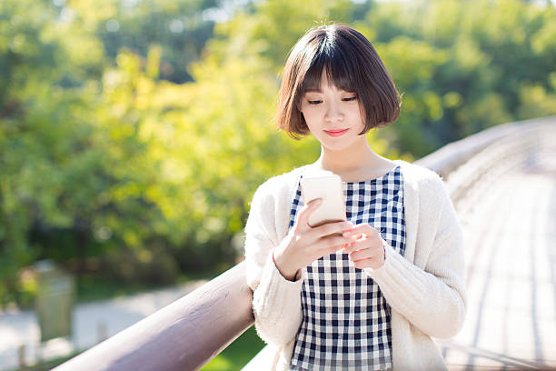 istock young girl using a mobile phone 504814676