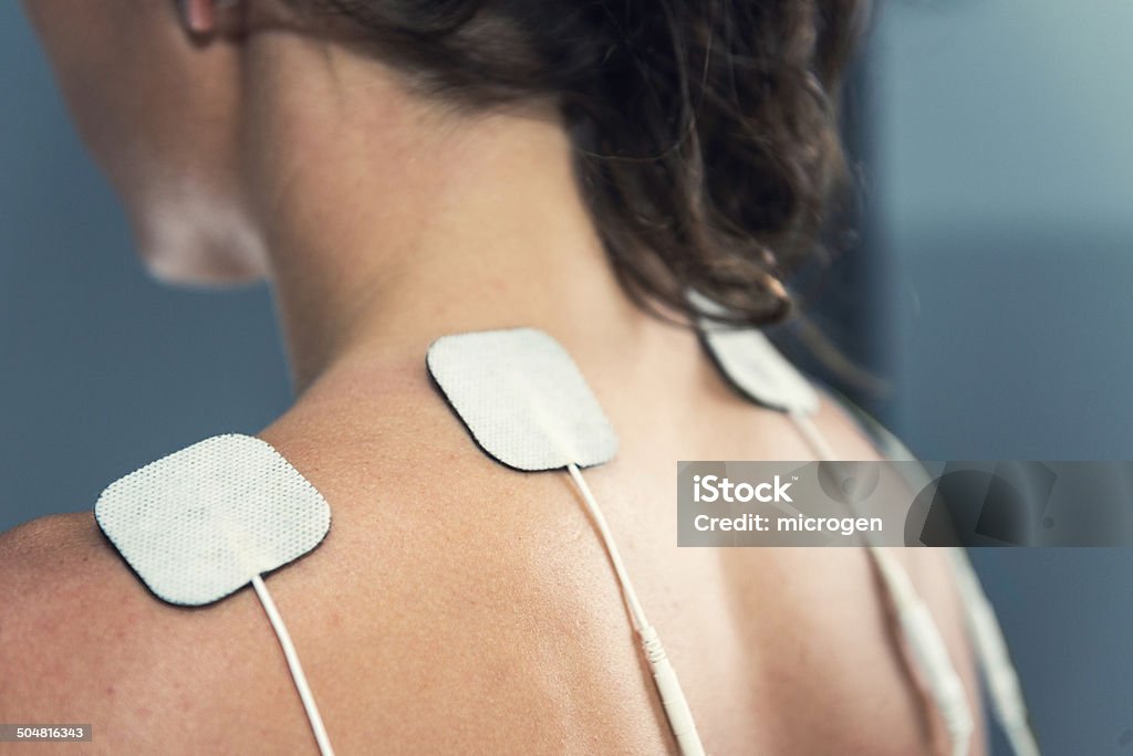 TENS electrodes TENS electrodes - treatment on shoulders Electrode Stock Photo