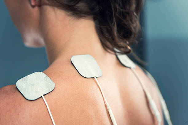 TENS electrodes TENS electrodes - treatment on shoulders electrode stock pictures, royalty-free photos & images