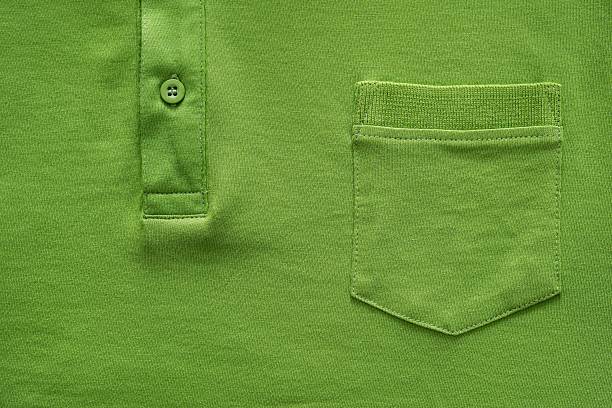 part shirt closeup of green color closeup part of a shirt from cotton fabric of green color with a big pocket and a fastener with the button pocket stock pictures, royalty-free photos & images