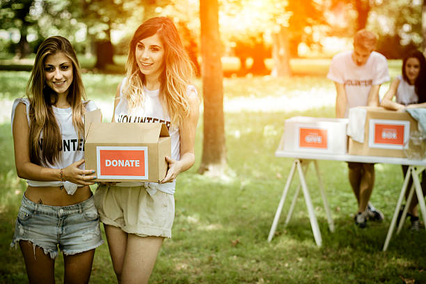 istock Group of volunteers with donation boxes 504816945