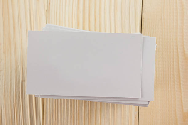 istock White blank business visit card, ticket, pass, present  wooden background 504817046
