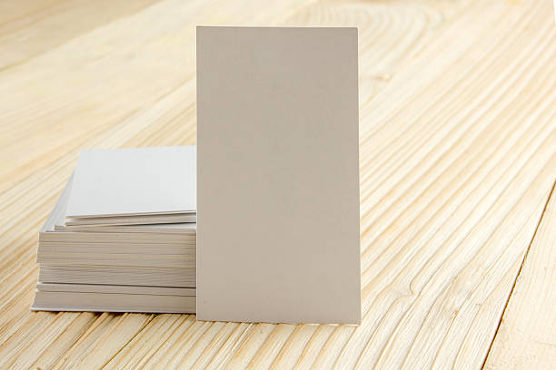 istock White blank business visit card, ticket, pass, present  wooden background 504817086