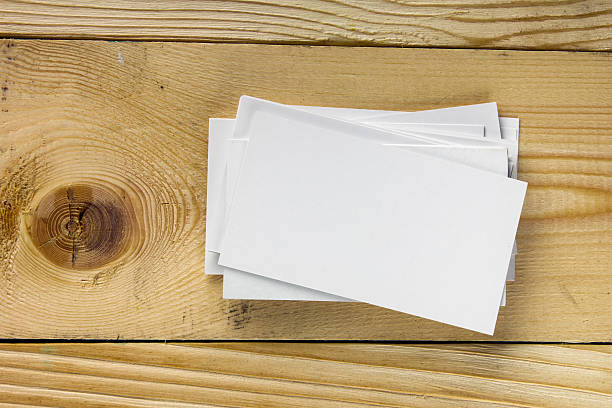 istock White blank business visit card, ticket, pass, present  wooden background 504817206