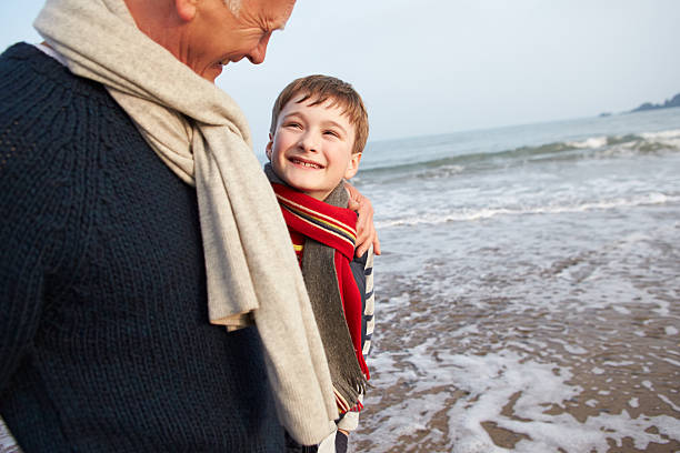 istock Grandfather And Grandson Walking On Winter Beach 504817343