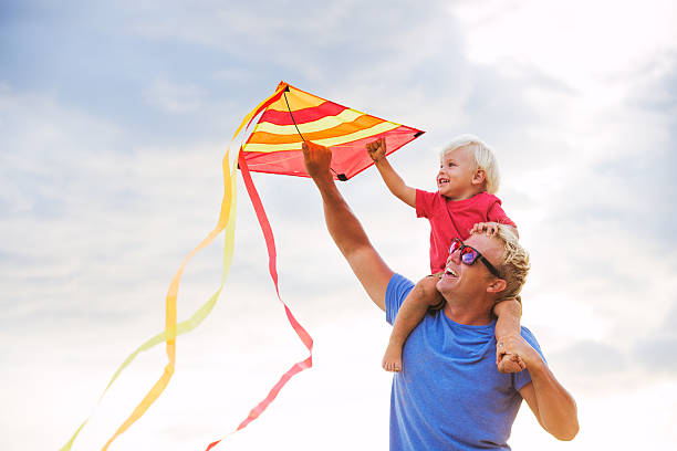 istock Father and son playing with kite 504817725