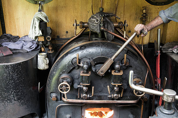 On the footplate The cab of a steam engine being driven on a railway track firebox steam engine part stock pictures, royalty-free photos & images