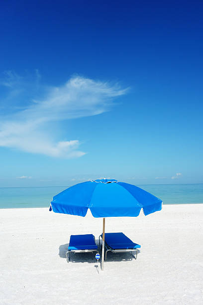 istock Sun umbrella and lounge chairs on beach 504819765