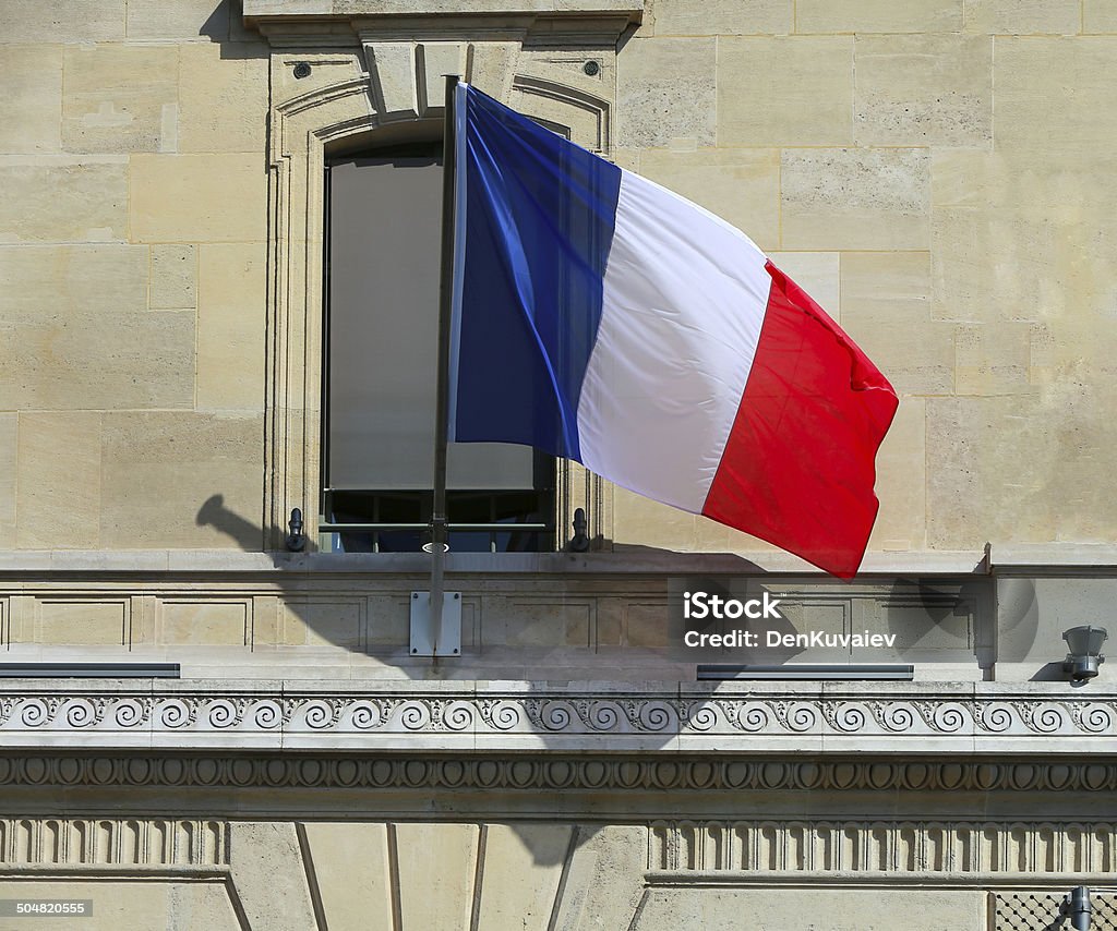 French Flag at Facade French Flag at Facade of Historic Building in Paris Architecture Stock Photo
