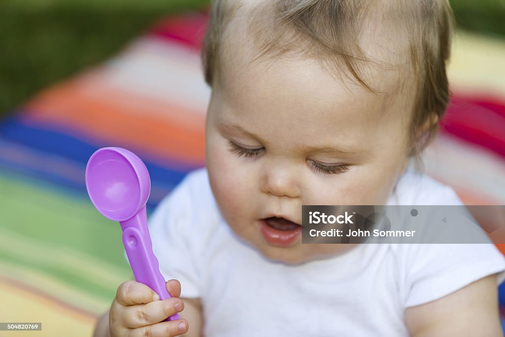 Hungry baby Cute baby holding a spoon 6-11 Months Stock Photo