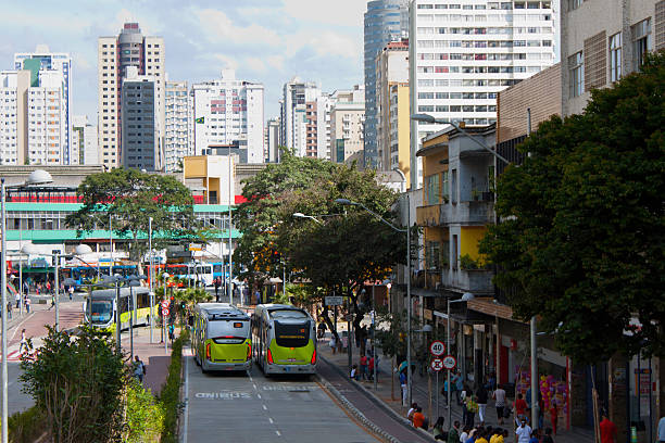 Two Buses in Belo Horizonte with buildings on the background Public transportation system in Belo Horizonte, state of Minas Gerais, Brazil. Picture taken at Paraná Street, downtown of Belo Horizonte. belo horizonte photos stock pictures, royalty-free photos & images
