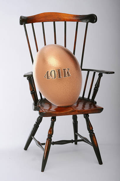 Nest Egg Resting. 401K nest egg resting in a chair. golden nest egg taxes stock pictures, royalty-free photos & images