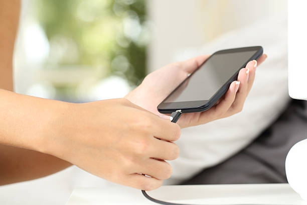 istock Woman hands plugging a charger in a smart phone 504821714