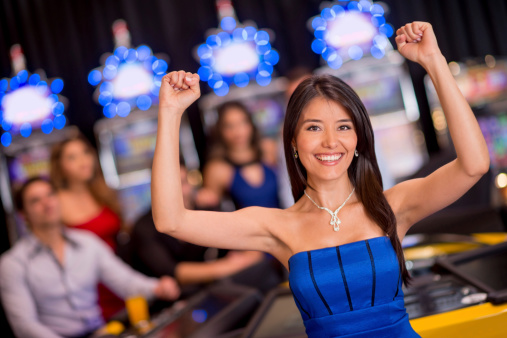 Happy woman winning at the casino