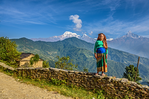Dhampus, Nepal - October 27, 2015 : Nepalese woman in front of her home in the Himalayas mountains near Pokhara