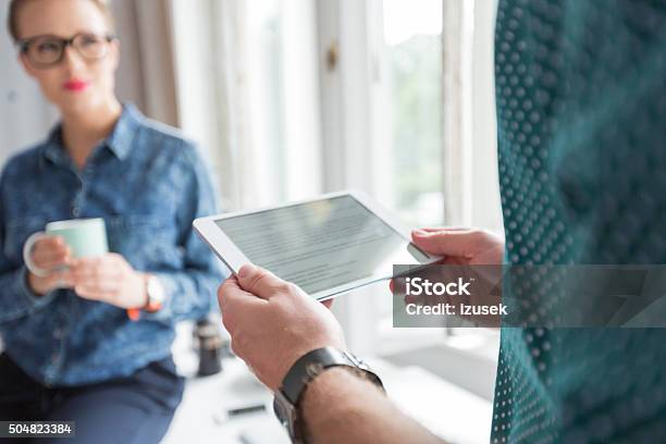 Man Holding A Digital Tablet In An Office Close Up Stock Photo - Download Image Now