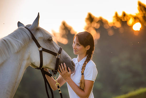 istock Young woman standing with horse 504825164