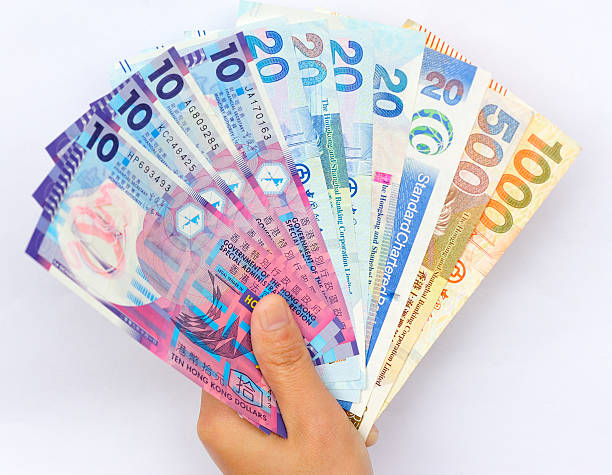 istock hand with hong kong dollars 504825698