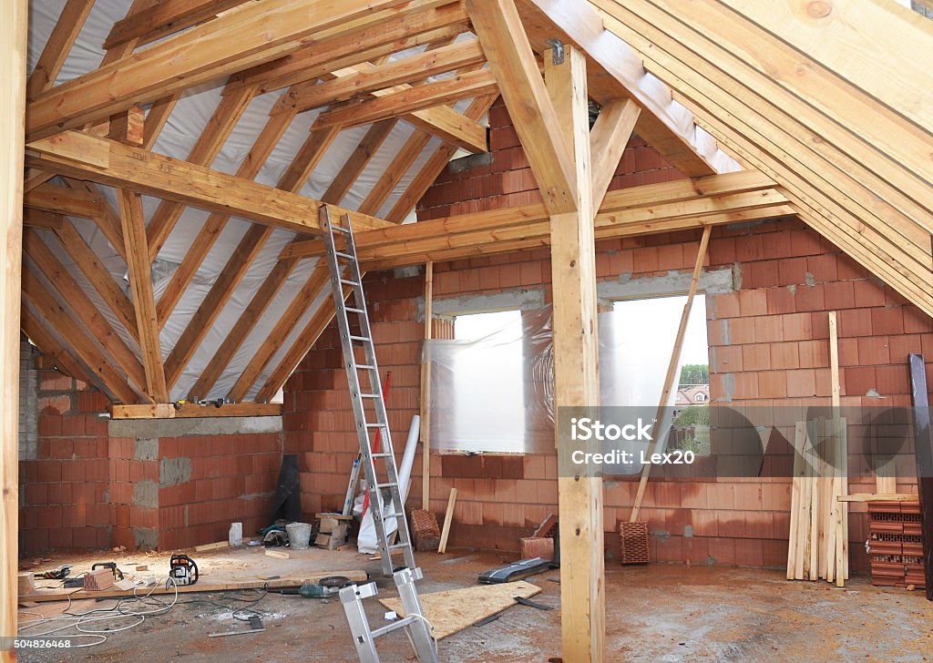 Building Attic Interior. Wooden Roof Frame House Construction. Building Attic Interior. Roofing Construction Indoor. Wooden Roof Frame House Construction. Home Addition Stock Photo