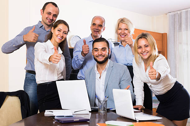 istock colleagues looking at laptop and smiling 504827060