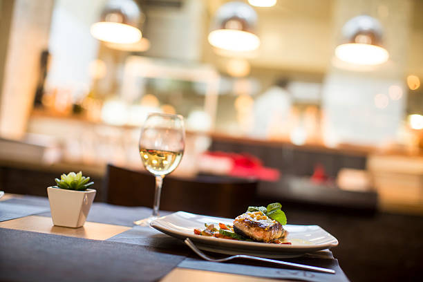 istock Grilled salmon with sauce and herbs served at restaurant 504828526