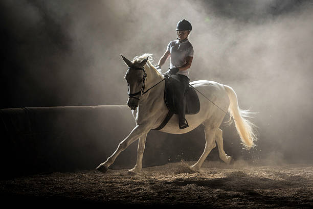 Woman riding horse Woman riding horse on ranch at night. saddle photos stock pictures, royalty-free photos & images