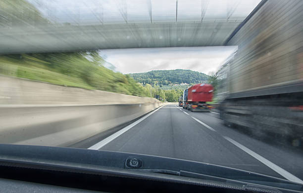 istock Car that overtake a truck in motorway 504832098