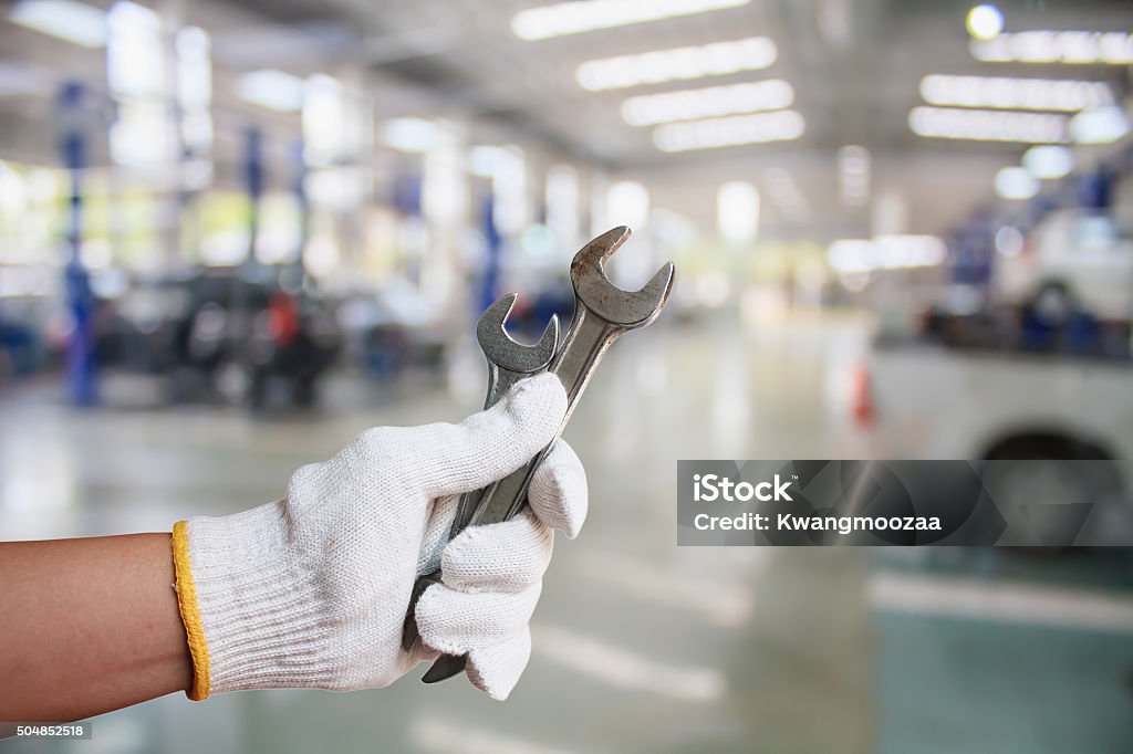 Hand of professional Auto mechanic with wrench Hand of professional Auto mechanic with wrench, Auto repair service Auto Repair Shop Stock Photo