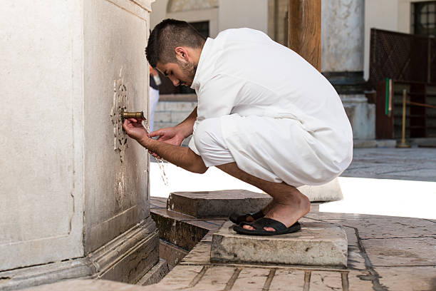 Muslim Man Preparing To Take Ablution In Mosque