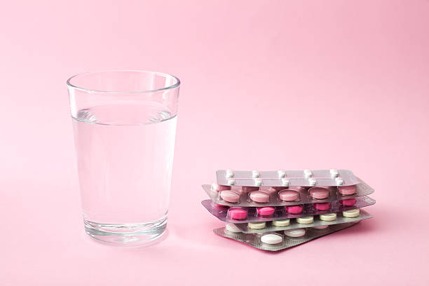 Pills and glass of water Pills and glass of water with copy space tablets blister stock pictures, royalty-free photos & images