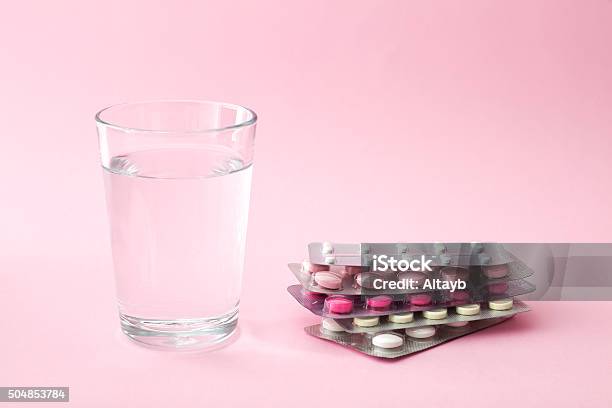 Pills And Glass Of Water Stock Photo - Download Image Now - Birth Control Pill, Pill, Blister