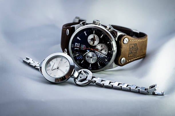 Singapore, Singapore - January 8, 2016: Studio shot of  Tag Heuer formula one limited edition watch and ladies Armani watch