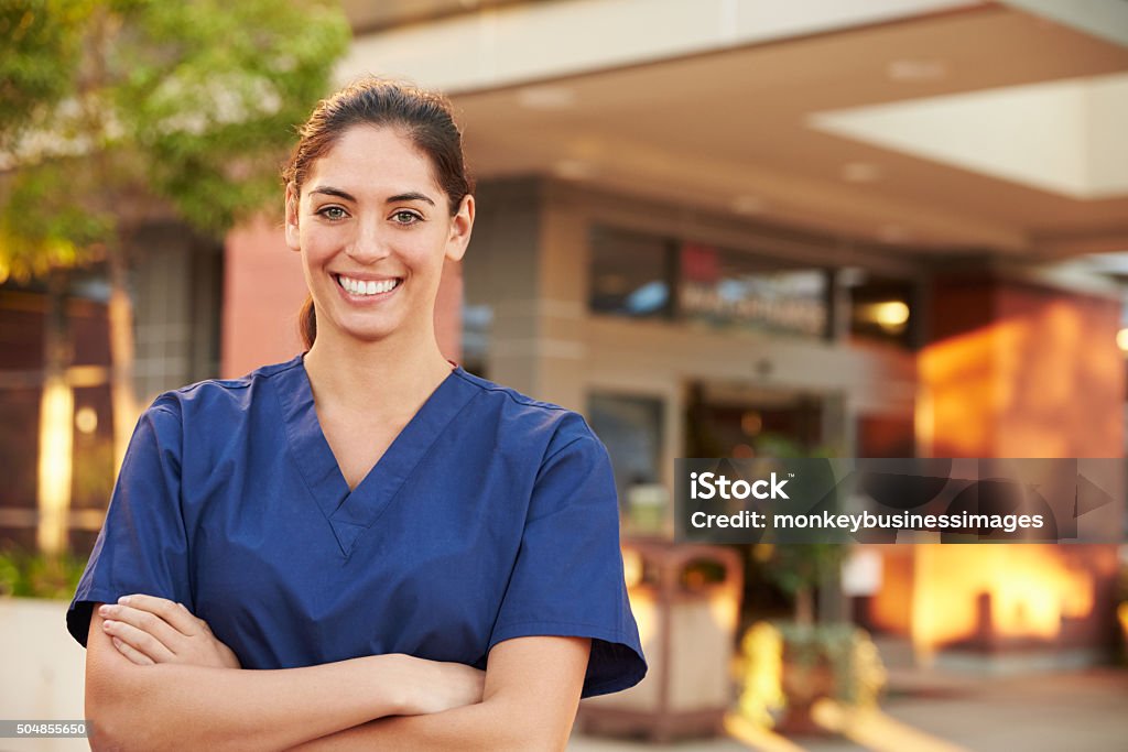 Portrait Of Female Doctor Standing Outside Hospital Medical Scrubs Stock Photo