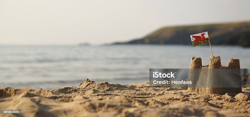 Beach, sea, sandcastle and  Welsh Flag Building - Activity Stock Photo