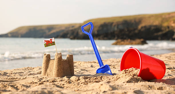 istock Beach, sea, buckets, spades and Welsh Flag 504856177