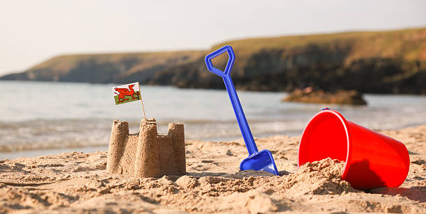 istock Beach, sea, buckets, spades and Welsh Flag 504856421