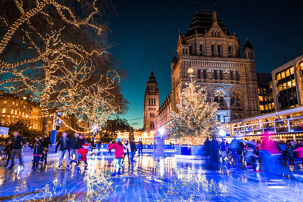 People Ice Skating, Natural History Museum in Kensington, London, UK London, UK - December 21, 2015: long exposure shot of people ice skating outside the Christmas ice rink outside the Natural History Museum in Kensington, London, UK. ice skating photos stock pictures, royalty-free photos & images