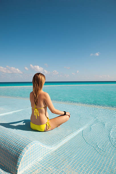 istock On Vacation Practicing Yoga Lotus Pose in Infinity Pool Vt 504857687