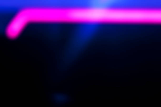 istock Defocused pink line on black and blue background 504857886