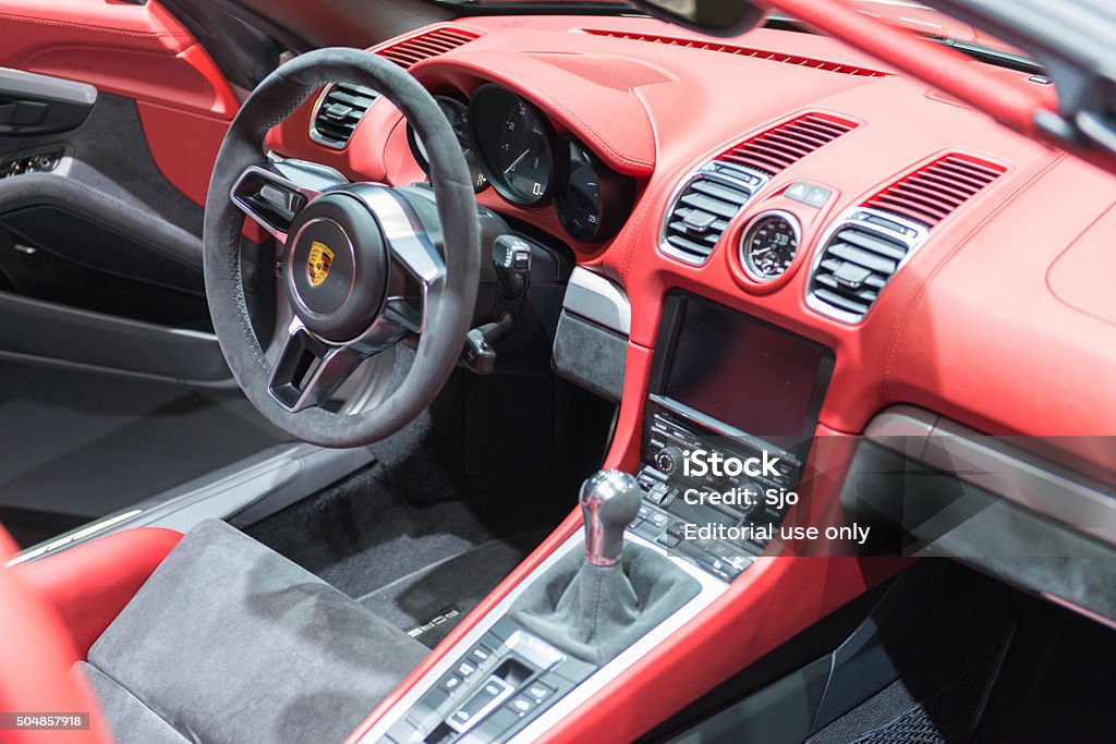 Porsche Boxster Spyder open sports car interior Brussels, Belgium - Januari 12, 2016: Red and grey interior on a Porsche Boxster Spyder open sports car at the Porsche stand. The Porsche Boxster Spyder is the lightweight version of the Porsche Boxster, the interior is fitted with red leather, grey alcantara and aluminium trim. The car is on display during the 2016 Brussels Motor Show.  Porsche Stock Photo