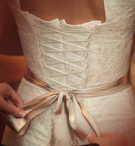 istock Bride is putting on her white wedding dress 504858436