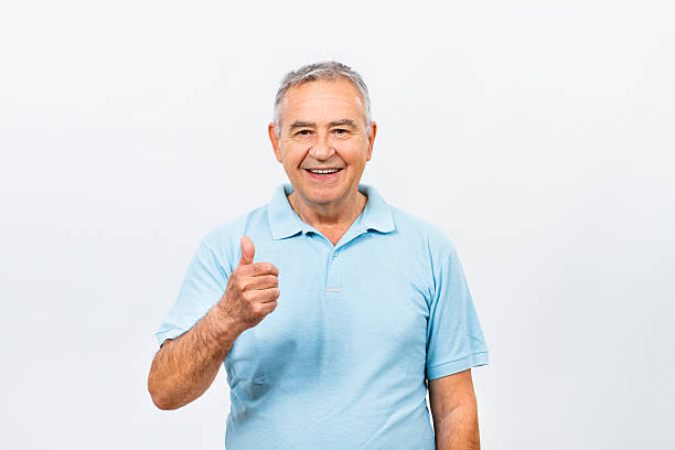 Happy senior man with thumb up stock photo