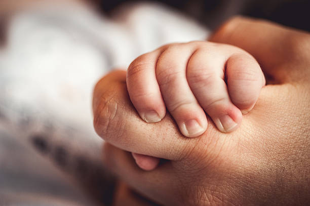 istock Newborn Baby Holding Mothers Hand 504859006