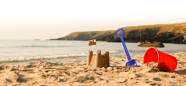 istock Beach, sea, buckets, spades and Welsh Flag 504859183