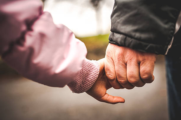 istock Father and Daughter Holding Hands 504860232