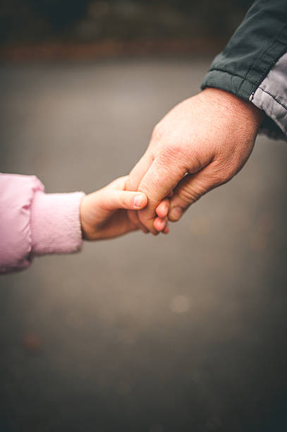 istock Father and Daughter Holding Hands 504860406