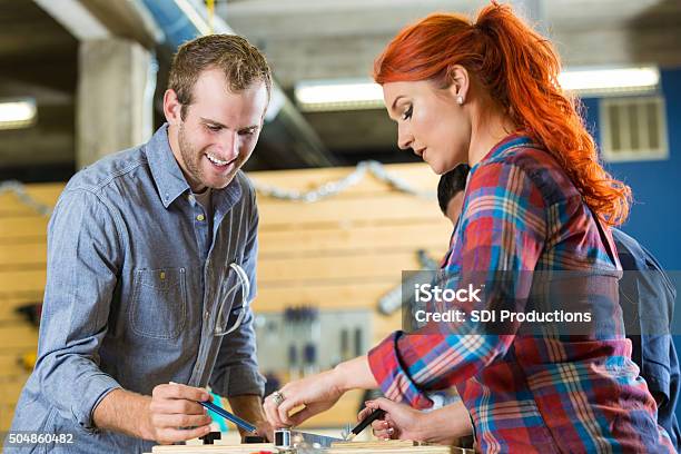 Young Entrepreneurs Working On Project In Woodworking Makerspace Stock Photo - Download Image Now