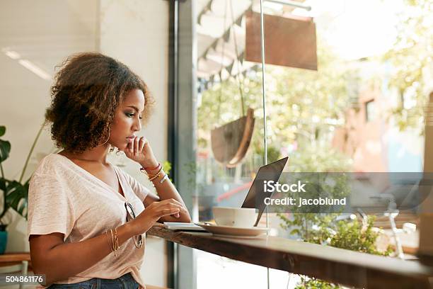 Young Black Woman At Cafe Using Laptop Stock Photo - Download Image Now - Coffee Shop, Working, Women