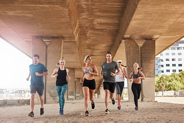 istock Group of athletes running under bridge 504862646
