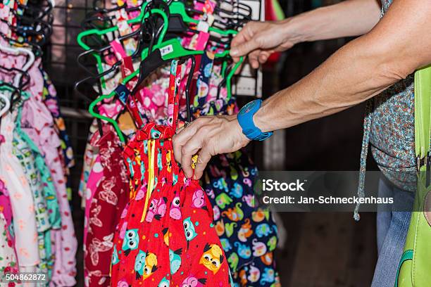 Hand Is Looking At A Market By Childrens Clothes Stock Photo - Download Image Now - Flea Market, Number 2, School Building